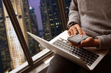 Two people working together over a computer