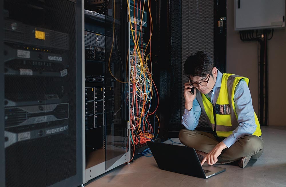 man-sitting-in-server-room